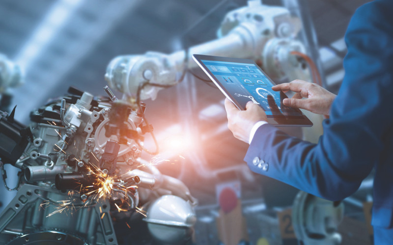 Man operating a robotic machine using an iPad.