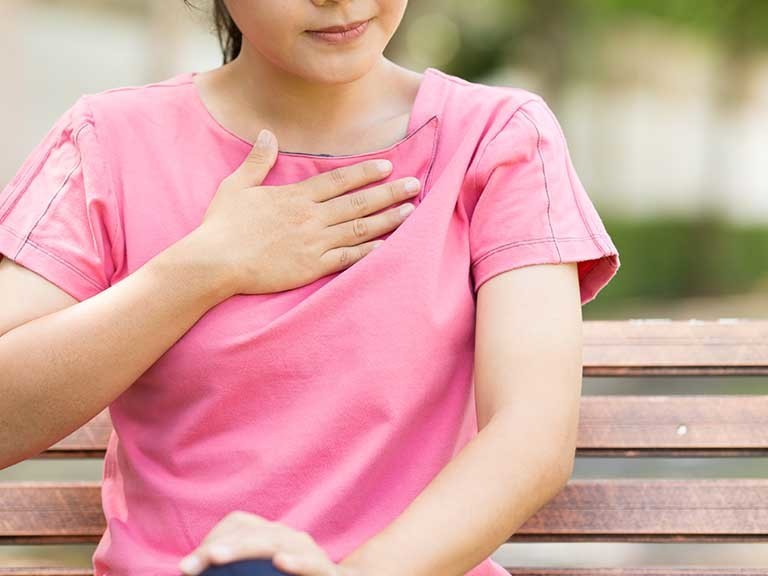 woman with hand on chest