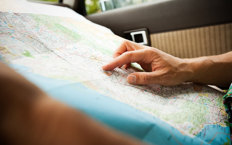 person pointing at a map