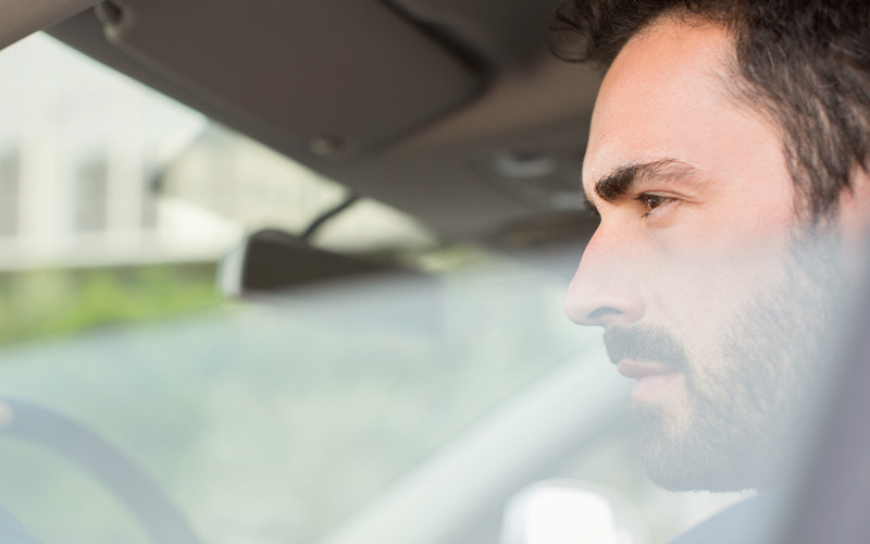 man driving a car