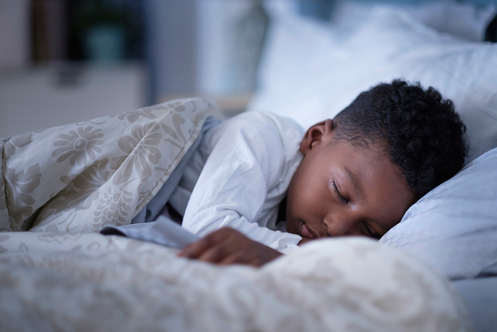 Boy sleeping in bed